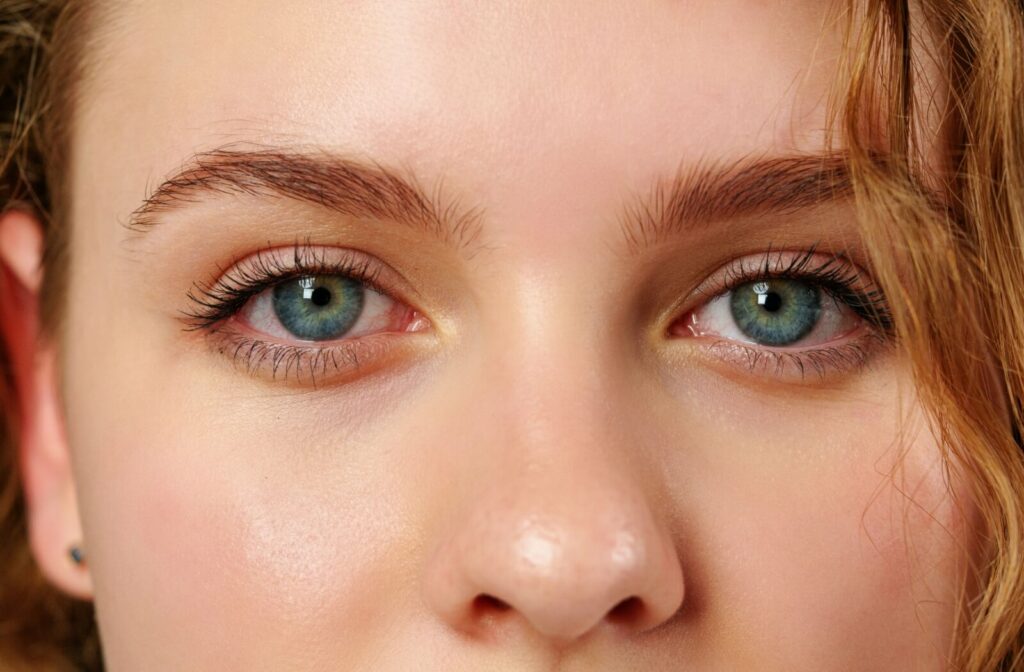 A close-up of a young person with beautiful blue eyes.