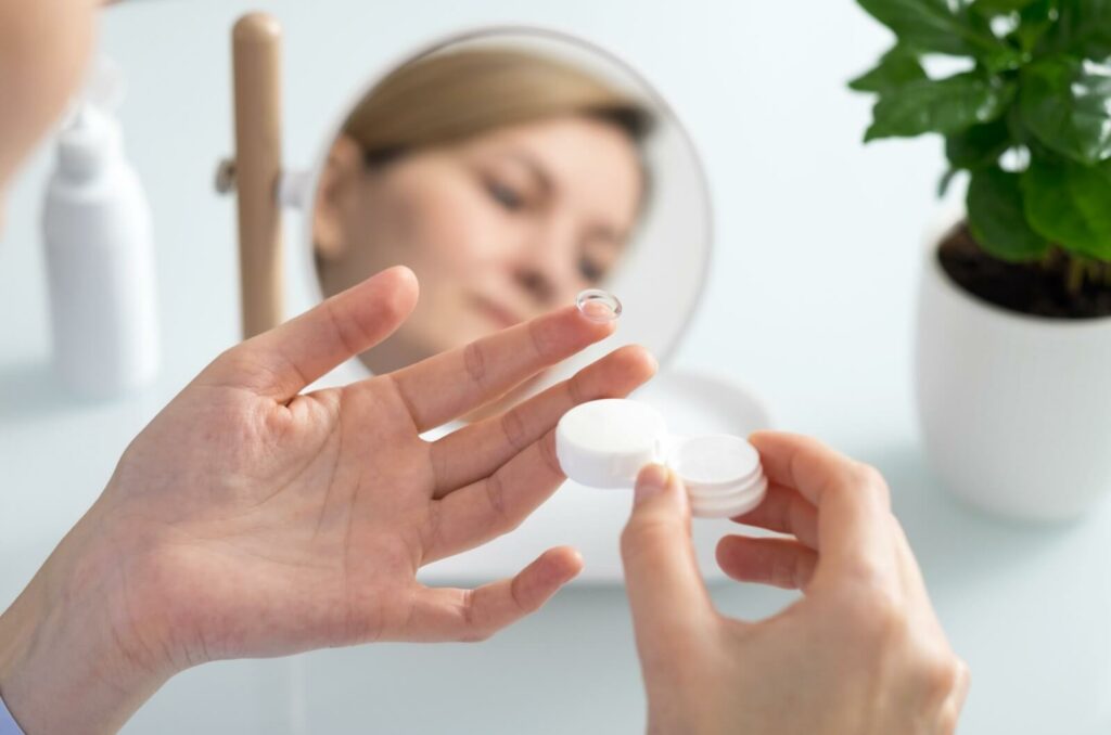 A patient pulls out their new monthly contact lenses to put in for the day.