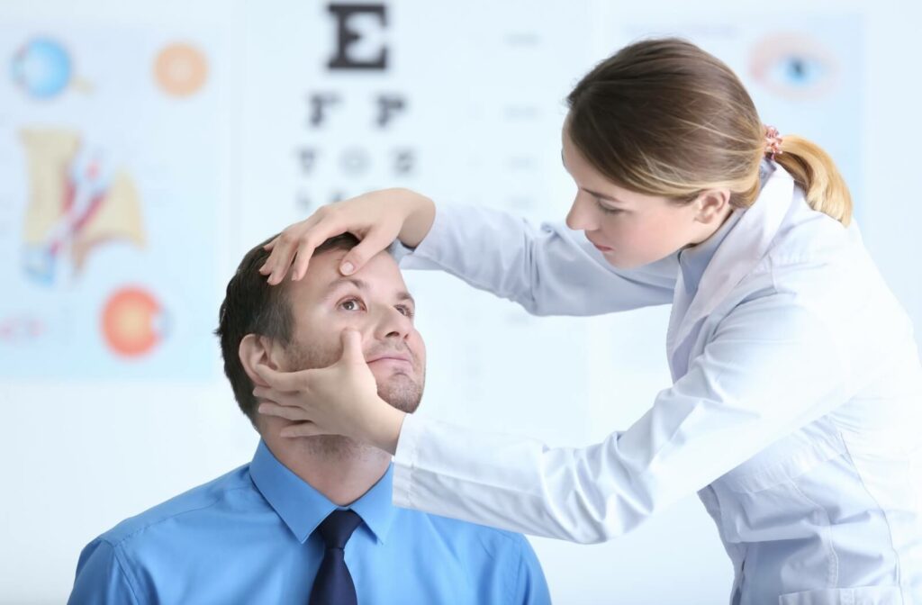 An optometrist inspects their patient's eyes to asses the cause of their dry, irritated eyes.